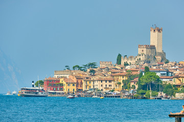 View of the beautiful Lake Garda in Veneto region, Malcesine town and old castle on rock in the summer time , Italy