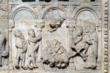 Bas-relief of Maestro Nicolo' (12th century), group to the right of the door of the Basilica of St Zeno, UNESCO World Heritage Site, in Verona, Italy