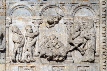 Bas-relief of Maestro Nicolo' (12th century), group to the right of the door of the Basilica of St Zeno, UNESCO World Heritage Site, in Verona, Italy