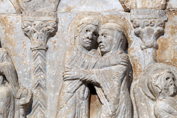 Fototapeta na wymiar Visitation of the Virgin Mary, medieval relief on the facade of Basilica of San Zeno in Verona, Italy