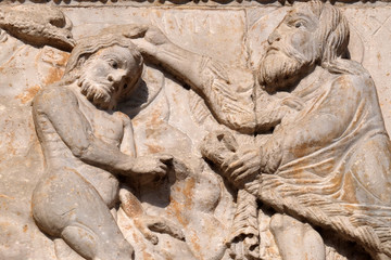 Baptism of the Christ, medieval relief on the facade of Basilica of San Zeno in Verona, Italy