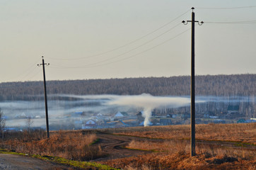 Early spring in the Ural village. People start working in gardens and orchards. And the first thing they burn last year's grass.
