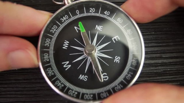 The person sets the compass needle to the north