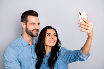 Close up photo couple she her he him his lady guy telephone smart phone hands arms make take selfies speak tell skype wear casual jeans denim shirts outfit clothes isolated light grey background