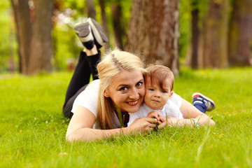 Beautiful blonde mother with her boy in park