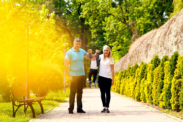 Happy family have fun outdoors, female and male play with baby boy