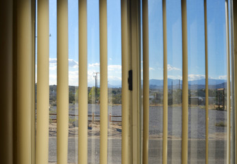 Vew through a curtain in a motel room on a suburban village in the american desert
