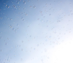 Soap bubbles fly in the blue sky