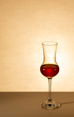 a glass of whiskey is on the table