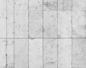 Full frame background of a modern and a bit broken wall or building exterior made of abstract stone slabs in black and white.
