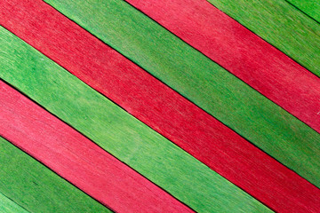 Green diagonal colored wooden background with red stripes
