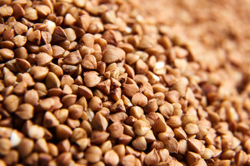 Buckwheat grains background. Selective focus