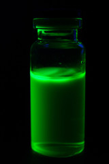 Vial green fluorescent paint in the UV-blacklight