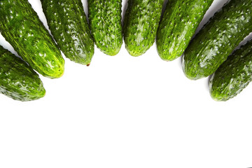 Green gherkins on white background