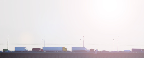 Fototapeta premium Traffic jam on the bridge at sunset, panoramic view. Transport background