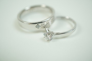 Close up two platinum diamond wedding rings isolated on white background