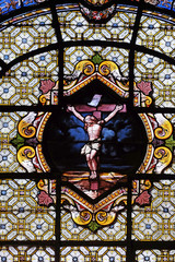 Jesus Christ on the cross, stained glass window in the Saint Sulpice Church, Paris, France