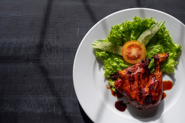 Grilled chicken leg on a plate