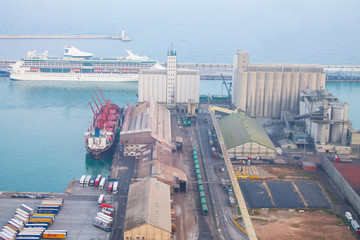 Top view of a cargo ship and an industrial harbor in Barcelona, Spain