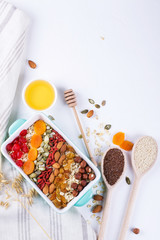 Oat flakes baking tray and various delicious ingredients for healthy breakfast