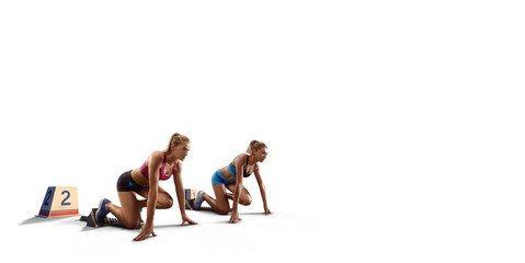 Isolated Female athletes sprinting. Women in sport clothes on starting line prepares to run on white background