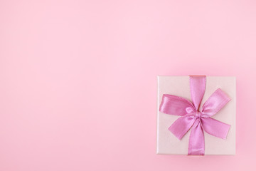 gift box with a bow on a pink background with a place for your design