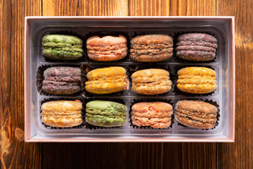 top view box of moldy macaroons on a wood table