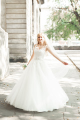 Fototapeta premium Beautiful bride spinning with perfect dress in the park
