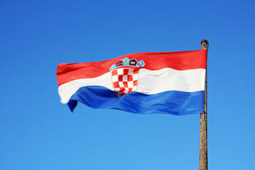 Fototapeta na wymiar Croatia flag waving on the blue sky.