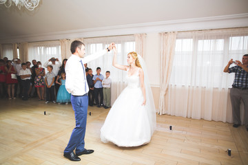 First wedding dance of newlywed couple in restaurant