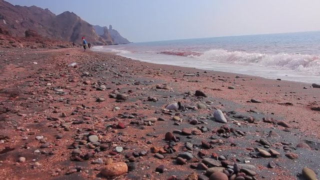 Beautiful panoramic view from stones to the red beach with mountains and Persian Gulf. Hormuz island. Iran