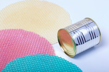 Round wafer cakes of different colors. For making waffle cake. Nearby there is a can of condensed milk to soak the cakes. On a white background.