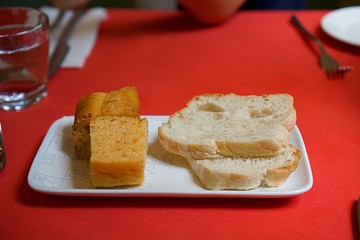 Variety of home made Italian bread    on red table in Italian restaurant. Authentic Italian bread. Italian entree.