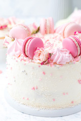 Wedding white cake with macarons and roses