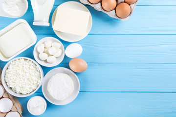 dairy products on blue wooden background, top view