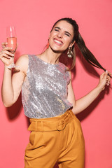 Portrait of glamour woman 20s in stylish outfit holding glass of champagne on party