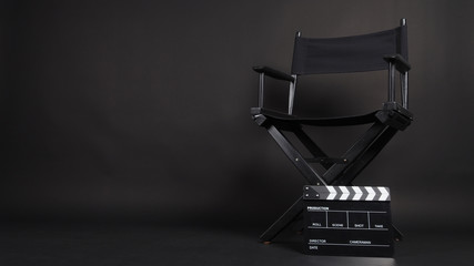Clapper board or movie slate with director chair use in video production or movie and cinema industry. It's all black color. - obrazy, fototapety, plakaty