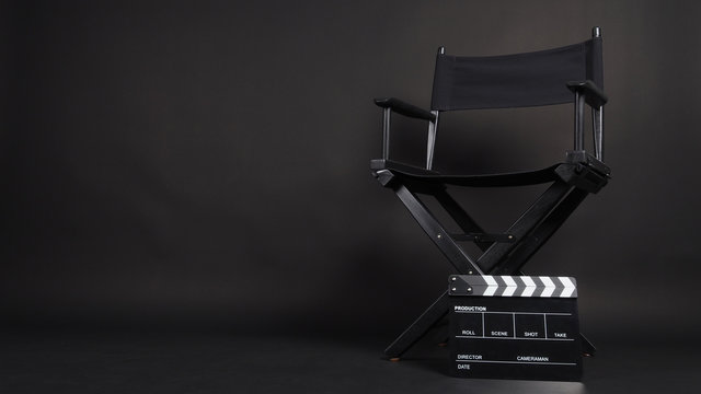 Clapper board or movie slate with director chair use in video production or movie and cinema industry. It's all black color.