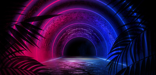 Round tunnel, light arch with tropical leaves. Abstract dark room background with neon illumination.