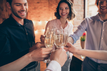 Cropped close-up wineglasses sparkles nice lovely attractive pretty elegant cheerful cheery positive guys ladies having fun greetings birthday festal lights in industrial loft interior room indoors