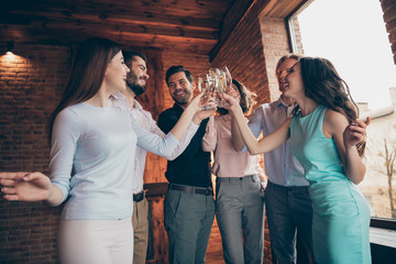 Company of nice attractive lovely gorgeous pretty cheerful glad positive guys ladies clinking wineglasses having fun bride wedding festal birthday day in wood brick industrial loft interior room