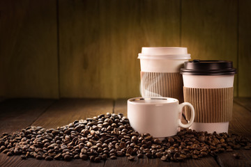 Coffee cup and coffee beans on wooden table