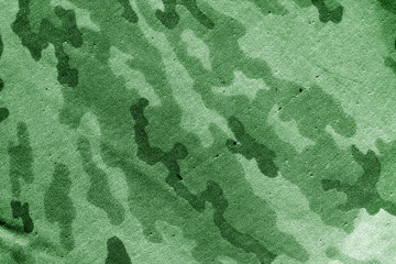 Dirty camouflage cloth in green tone.