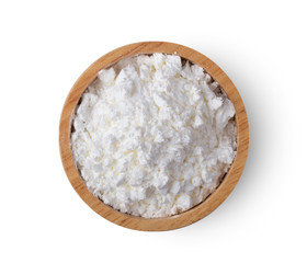 Pile of flour in wood bowl isolated on white background .top view