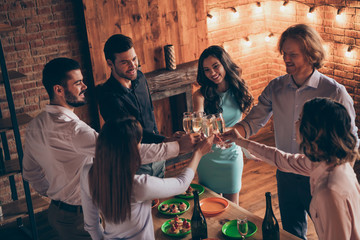 Above high angle view portrait of nice attractive lovely winsome cheerful positive ladies gentlemen having fun house romantic date evening event buffet snack in brick industrial loft interior room