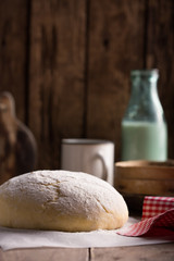 Dough and ingredients for it - eggs flour yeast on brown wooden background. Selective focus.