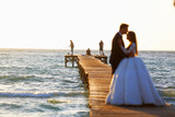 Wedding couple, bride, groom walking and posing on pier
