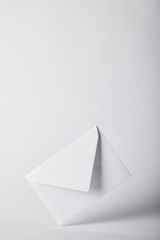 Fototapeta na wymiar white and empty envelope on grey background with copy space
