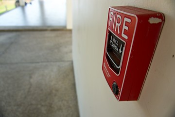 Fire alarm box on cement wall for warning and security system in the resort. Black and white background