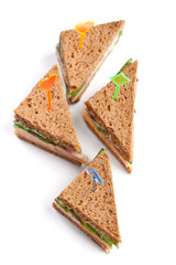 Group of tea sandwiches with  cheese, ham and lettuce isolated on white background